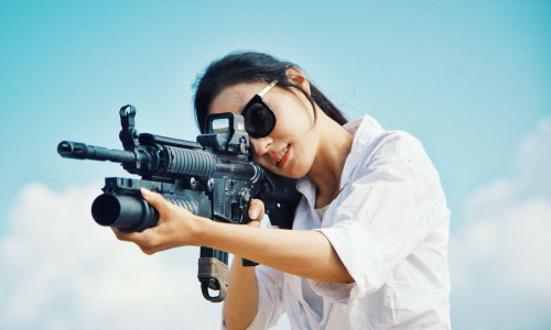 Girl aiming at a gun range